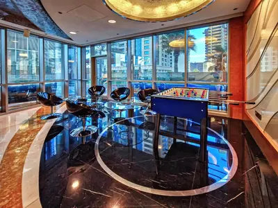 a room with a glass table with a chess board at 1BD in Ocean Heights, Dubai Marina for 4 Guests in Dubai