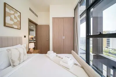 a bedroom with a white bed and a large window at PVH - Stylish 1BR Near Dubai Mall - Azizi Riviera in Dubai