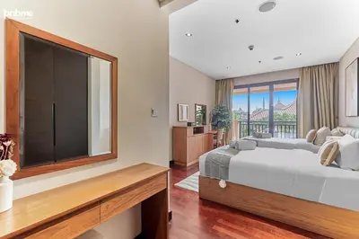 a bedroom with a large bed and a large window at bnbme - Luxury Anantara Palm Apt Beachfront Lagoon Pools Balcony & Spa Access in Dubai