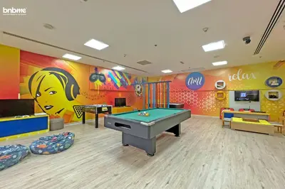 a play room with a pool table and a mural at bnbme - Luxury Anantara Palm Apt Beachfront Lagoon Pools Balcony & Spa Access in Dubai