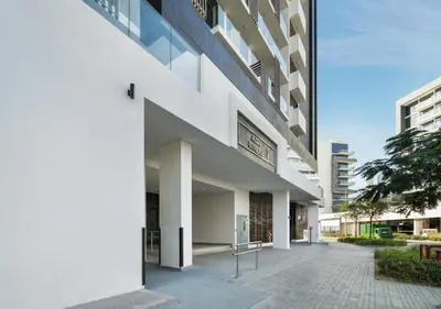 an external view of a white building at Bespoke Holiday Homes - Studio with Modern Amenities in Azizi Riviera in Dubai