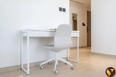a white desk with a chair in a room at Vogue JVC Binghatti Corner near Circle Mall, Two Bedroom Apartment with Balcony and City View, Access to all Amenities in Dubai