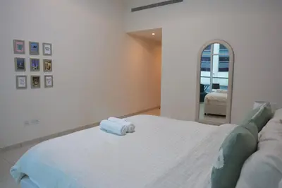 a bedroom with a bed with a towel on it at Nivis find- Luxury 1 BHK nearby Dubai Mall in Dubai