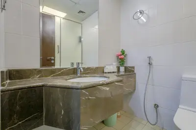 a bathroom with a sink and a mirror at Prime Downtown Male Dormitory Comfort Meets Convenience in Dubai