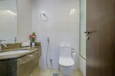 a bathroom with a toilet and a sink at Prime Downtown Male Dormitory Comfort Meets Convenience in Dubai
