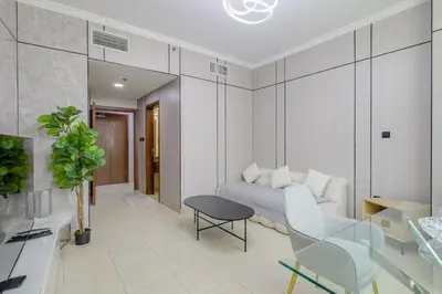 a living room with a couch and a table at Prime Downtown Male Dormitory Comfort Meets Convenience in Dubai