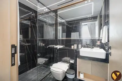 a bathroom with a toilet and a sink at Vogue JVC Binghatti Corner near Circle Mall, One Bedroom Apartment with Balcony and City View, Access to all Amenities in Dubai