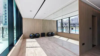 a room with large windows in a building at Vogue JVC Binghatti Corner near Circle Mall, One Bedroom Apartment with Balcony and City View, Access to all Amenities in Dubai