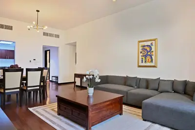 a living room with a couch and a table at Luxury 2BR with Contemporary Design & Great Views in Dubai