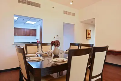 a dining room with a wooden table and chairs at Luxury 2BR with Contemporary Design & Great Views in Dubai