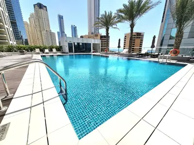 a swimming pool in the middle of a city at SUNRISE HOMES - Charming 1-BR Just a walk to JBR Beach in Dubai