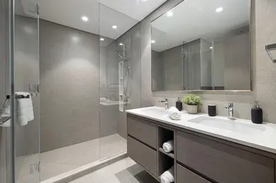 a bathroom with a sink and a glass shower at Luxury 2BR Burj Fountain View Walk to Dubai Mall in Dubai