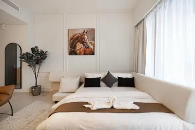 a bedroom with a large bed with two towels on it at 2BR Walk to Burj Mall & Opera Pool View in Dubai