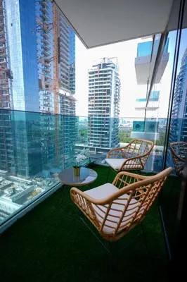 a balcony with chairs and a table on a building at Modern 1BR 4 Guests Dubai World Trade Center in Dubai