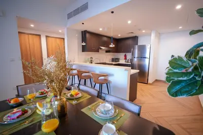a kitchen and dining room with a table and chairs at Modern 1BR 4 Guests Dubai World Trade Center in Dubai