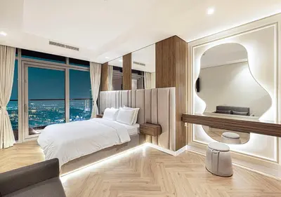 a bedroom with a bed and a large window at Paramount Midtown Hotel - Luxury Apartments & Infinity Pool with Burj Khalifa View in Dubai