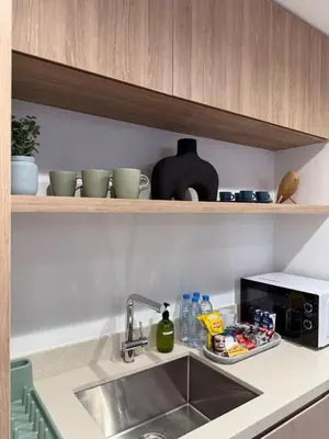 a kitchen counter with a sink and a microwave at Stylish 2BR - Burj Khalifa - Waterfront View - Fully Furnished in Dubai
