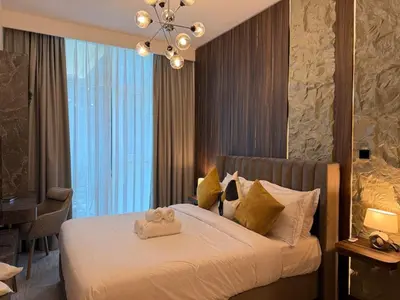 a bedroom with a bed with two teddy bears on it at Stylish 2BR - Burj Khalifa - Waterfront View - Fully Furnished in Dubai