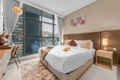 a bedroom with a large bed and a large window at Serene Palm Studio - Rooftop Infinity Pool & Private Beach Access in Dubai