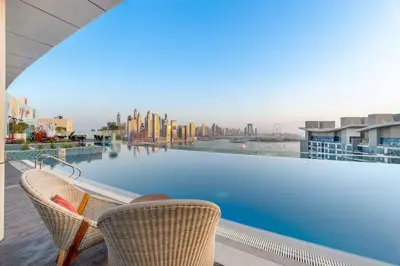 a view of a swimming pool on top of a building at Stunning Palm Studio - Rooftop Infinity Pool & Private Beach Access - MaxStays in Dubai