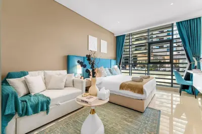 a living room with a bed and a couch at Stunning Palm Studio - Rooftop Infinity Pool & Private Beach Access - MaxStays in Dubai