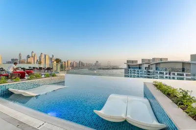 a swimming pool on the roof of a building at Stunning Palm Studio - Rooftop Infinity Pool & Private Beach Access - MaxStays in Dubai