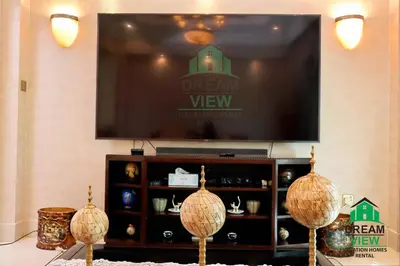 a flat screen tv sitting on top of a entertainment center at Souk AL Bahar Burj Khalifa View from main door, luxury Apartment, Dream view holiday homes in Dubai