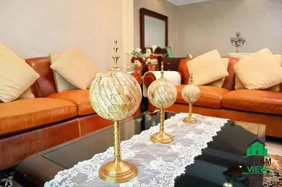 a living room with two trophies on a table at Souk AL Bahar Burj Khalifa View from main door, luxury Apartment, Dream view holiday homes in Dubai