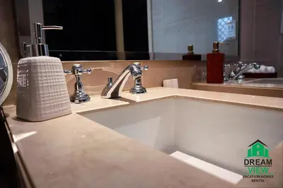 a bathroom with a sink and a mirror at Souk AL Bahar Burj Khalifa View from main door, luxury Apartment, Dream view holiday homes in Dubai