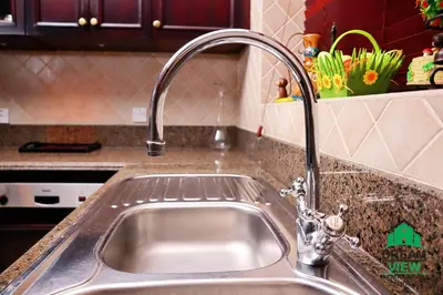 a kitchen sink with a faucet in a kitchen at Souk AL Bahar Burj Khalifa View from main door, luxury Apartment, Dream view holiday homes in Dubai