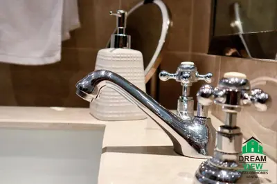 a bathroom sink with a faucet and a soap dispenser at Souk AL Bahar Burj Khalifa View from main door, luxury Apartment, Dream view holiday homes in Dubai
