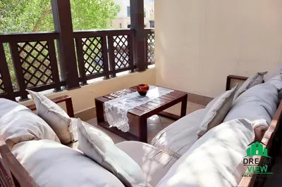 a room with couches and a table on a balcony at Souk AL Bahar Burj Khalifa View from main door, luxury Apartment, Dream view holiday homes in Dubai