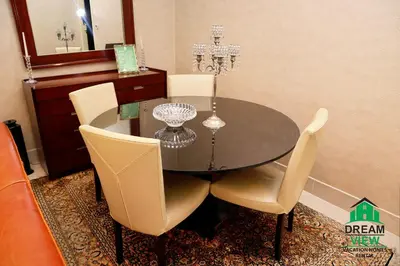a dining room with a table and chairs and a mirror at Souk AL Bahar Burj Khalifa View from main door, luxury Apartment, Dream view holiday homes in Dubai