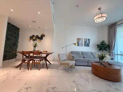 a living room with a couch and a table at Premium 1BR W Canal & Burj View in Al Habtoor City in Dubai