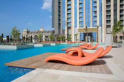 a swimming pool with orange inflatables in a building at Premium 1BR W Canal & Burj View in Al Habtoor City in Dubai