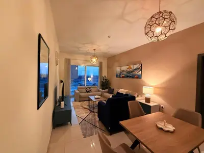 a living room with a couch and a table at Stunning Park View 1Bhk 4pax in Dubai
