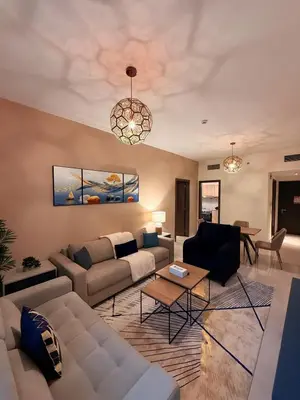 a living room with a couch and a table at Stunning Park View 1Bhk 4pax in Dubai