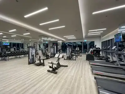 a gym with treadmills and machines in a building at Vogue Creek Harbour, Harbour Views Tower Waterfront Living Close to Downtown, Burj Khalifa and Dubai Mall, One Bedroom Apartment with Balcony and Canal View, Access to all Amenities in Dubai