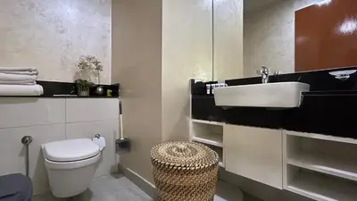 a bathroom with a white toilet and a sink at Bespoke Holiday Homes - Upscale 1BR Penthouse in Millenium Binghatti in Dubai