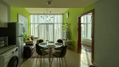 a living room with a table and chairs at Bespoke Holiday Homes - Upscale 1BR Penthouse in Millenium Binghatti in Dubai