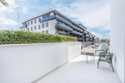 a balcony with chairs and a table and a building at Modern Family Home with Dubai Skyline Views in Dubai