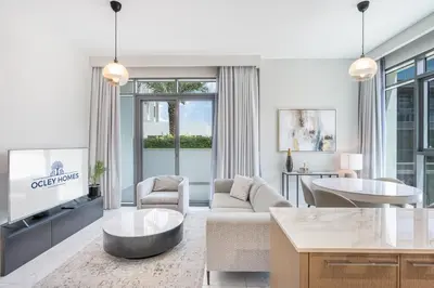 a living room with a couch and a table at Modern Family Home with Dubai Skyline Views in Dubai
