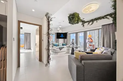 a living room with two couches and a dining room at Burj Khalifa View - Immersive Expérience - Downtown - DUBAI 3BR in Dubai