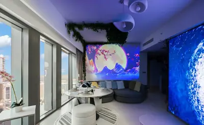 a living room with a table and a large screen at Burj Khalifa View - Immersive Expérience - Downtown - DUBAI 3BR in Dubai