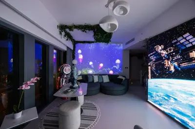 a living room with a large tv and a large aquarium at Burj Khalifa View - Immersive Expérience - Downtown - DUBAI 3BR in Dubai