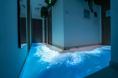 a room with a wave floor with blue lights at Burj Khalifa View - Immersive Expérience - Downtown - DUBAI 3BR in Dubai