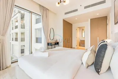 a bedroom with a large white bed and a large window at Lagoon and Beach Access, Near Festival City Mall, Mins From Downtown Dubai, Rosewater at Creek Beach Building 2, Creek Beach by Deluxe Holiday Homes in Dubai