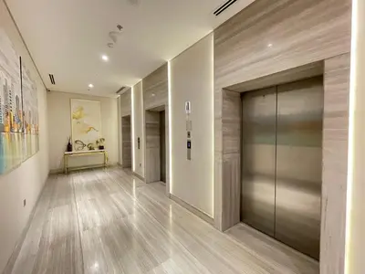 a hallway with a large glass door in a building at Spacious Studio with full Burj Khalifa view Jaddaf in Dubai