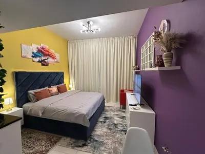 a bedroom with a bed and a purple wall at Livincci - Luxury Studio in Dubai Marina - 16 in Dubai