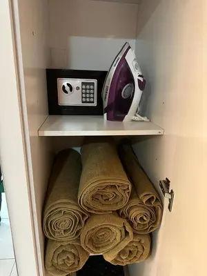 a toaster sitting on a shelf next to towels at Livincci - Luxury Studio in Dubai Marina - 16 in Dubai